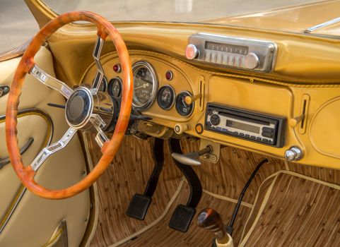 Driving position vintage yellow car after a recent upgrade.