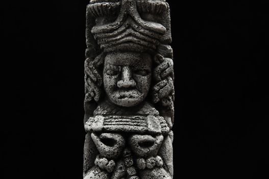 One Ancient Mayan Statue on a Black Background