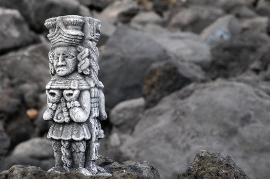 Ancient Maya Statue on the Rocks near the Ocean