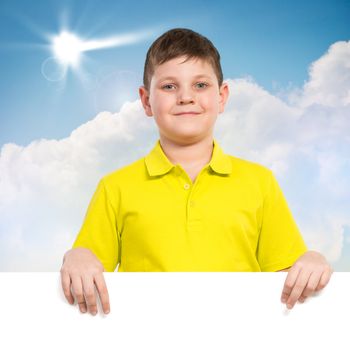 boy holding a white banner. place for text