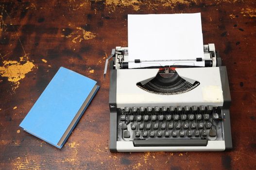 Old Vintage Travel Typewriter on a Brown Wooden Table