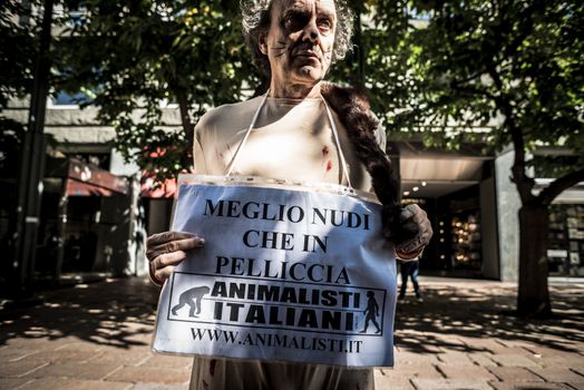 MILAN, ITALY - SEPTEMBER 17: Animalisti Italiani protest on September 17, 2013. Animal right association 'Animalisti Italiani' protest against furs and fashion, in famous fashion Milan street Monte Napoleone