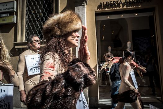 MILAN, ITALY - SEPTEMBER 17: Animalisti Italiani protest on September 17, 2013. Animal right association 'Animalisti Italiani' protest against furs and fashion, in famous fashion Milan street Monte Napoleone