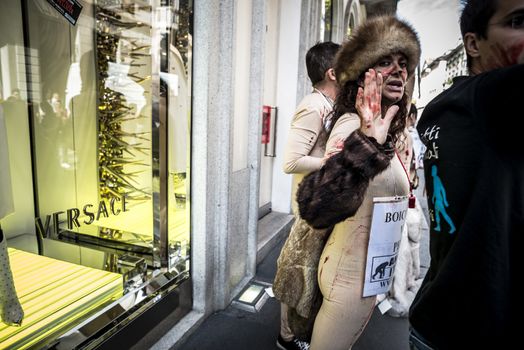 MILAN, ITALY - SEPTEMBER 17: Animalisti Italiani protest on September 17, 2013. Animal right association 'Animalisti Italiani' protest against furs and fashion, in famous fashion Milan street Monte Napoleone