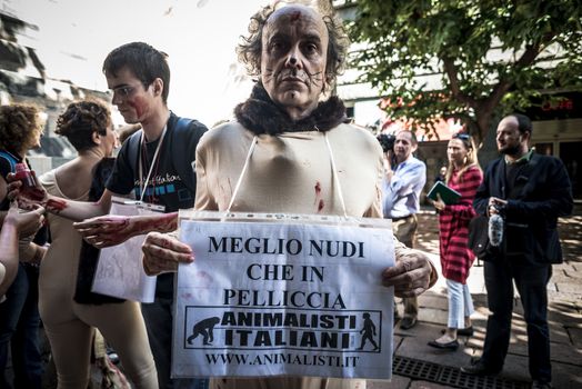 MILAN, ITALY - SEPTEMBER 17: Animalisti Italiani protest on September 17, 2013. Animal right association 'Animalisti Italiani' protest against furs and fashion, in famous fashion Milan street Monte Napoleone