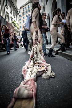 MILAN, ITALY - SEPTEMBER 17: Animalisti Italiani protest on September 17, 2013. Animal right association 'Animalisti Italiani' protest against furs and fashion, in famous fashion Milan street Monte Napoleone