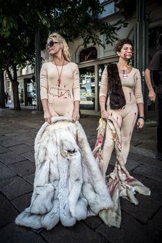 MILAN, ITALY - SEPTEMBER 17: Animalisti Italiani protest on September 17, 2013. Animal right association 'Animalisti Italiani' protest against furs and fashion, in famous fashion Milan street Monte Napoleone