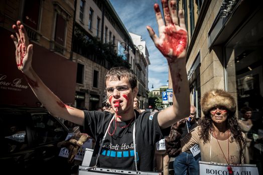 MILAN, ITALY - SEPTEMBER 17: Animalisti Italiani protest on September 17, 2013. Animal right association 'Animalisti Italiani' protest against furs and fashion, in famous fashion Milan street Monte Napoleone