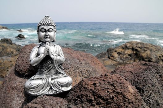 One Ancient Gray Buddha Statue Near The Ocean