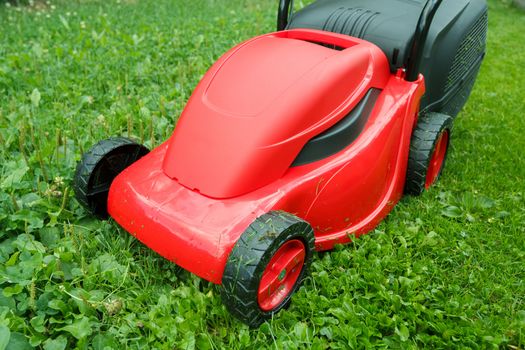  new lawnmower on green grass in cloudy day