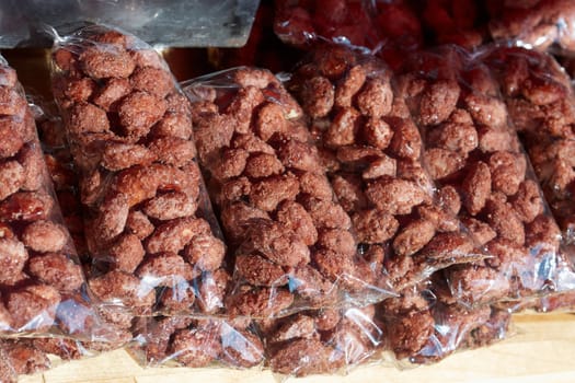 Heap of sweet roasted almonds  glazed with sugar in a market                            