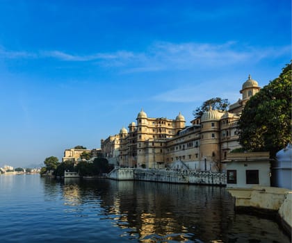 Romantic India luxury tourism concept background - Udaipur City Palace and Lake Pichola. Udaipur, Rajasthan, India