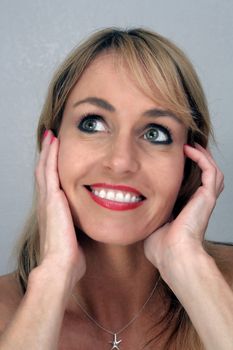 Studio close-up of a lovely blonde with a captivating smile.