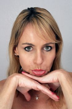 Studio close-up of a lovely pouting blonde.