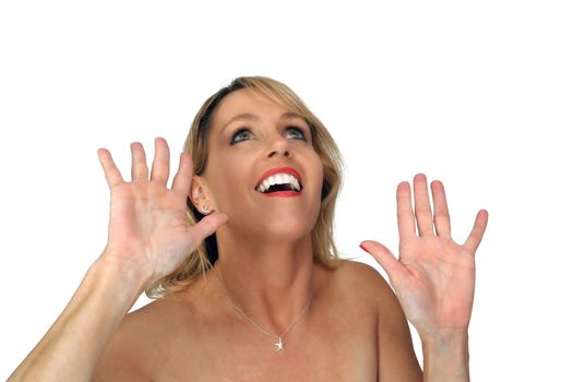 Studio close-up of a lovely blonde laughing with her hands raised.