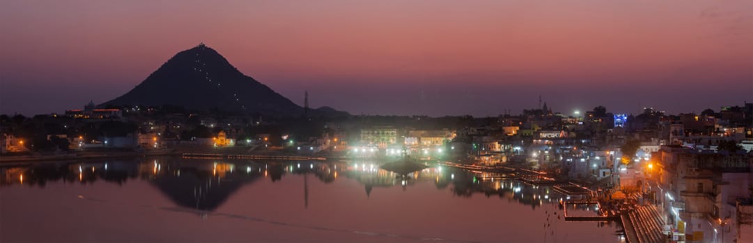 Panorama of Sacred Puskhar lake (Sagar) and ghats of  town Pushkar in twilight in the evening, Rajasthan, India