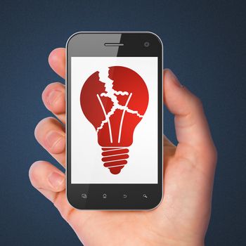 Business concept: hand holding smartphone with Light Bulb on display. Generic mobile smart phone in hand on Dark Blue background.