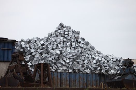 Metal container at a dump yard filled with a pile of sorted recyclable waste