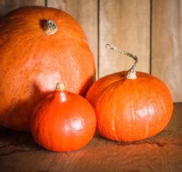 Pumpkins on grunge wooden backdrop, background table. Autumn, halloween, pumpkin