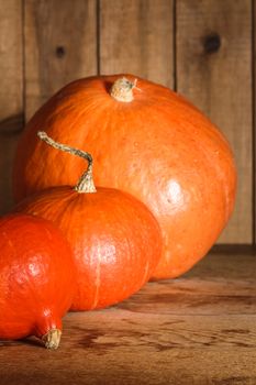 Pumpkins on grunge wooden backdrop, background table. Autumn, halloween, pumpkin