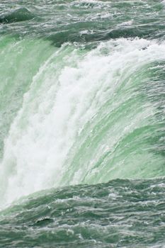 Blue-green water, falling down from Niagara falls.