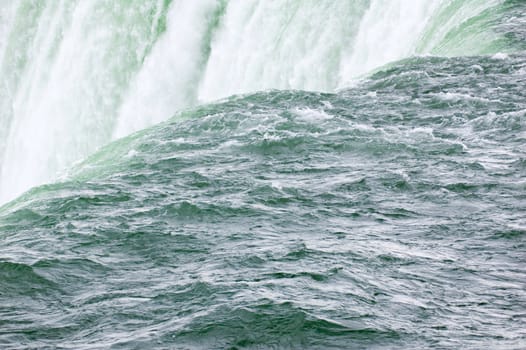 Blue-green water, falling down from Niagara falls.