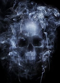 Photo montage of a human skull surrounded by cigarette smoke.