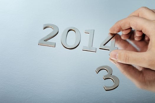 Man changing metallic numbers to year 201e