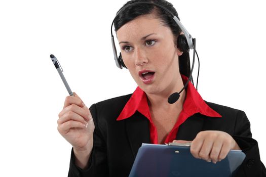 Woman with a headset and clipboard