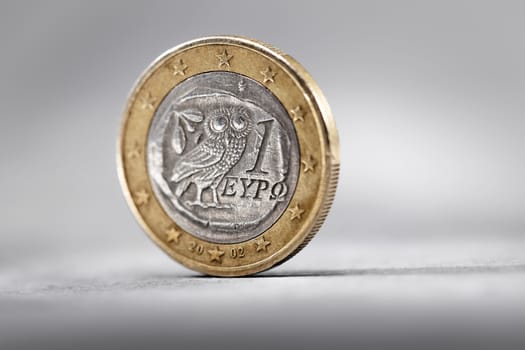 Greek 1 Euro Coin on grey background.