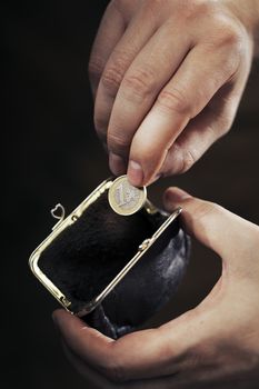Man taking the last Euro coin from his small change purse. Very short depth-of-field.