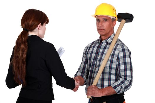 Tradesman shaking the hand of an engineer