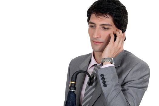 Weary businessman talking on his mobile phone