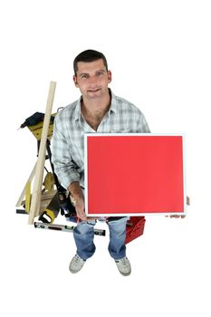 Carpenter posing with a picture frame