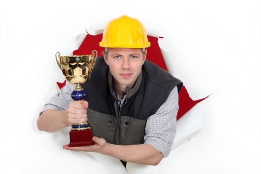 Worker holding a trophy cup.