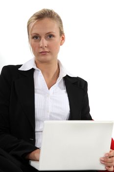 Thoughtful businesswoman with a laptop