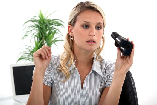 Young blond office worker with pair of binoculars