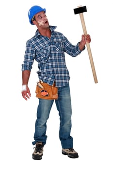 Injured workman with mallet in hand