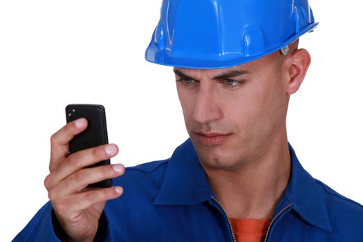 portrait of young blue collar reading sms against white background