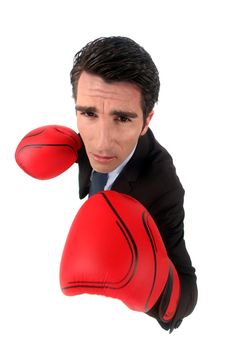 Businessman wearing boxing gloves