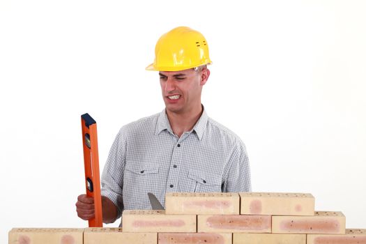 Bricklayer with a spirit level
