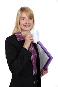 attractive female student holding mug of coffee and files