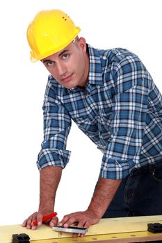 Carpenter marking a piece of wood