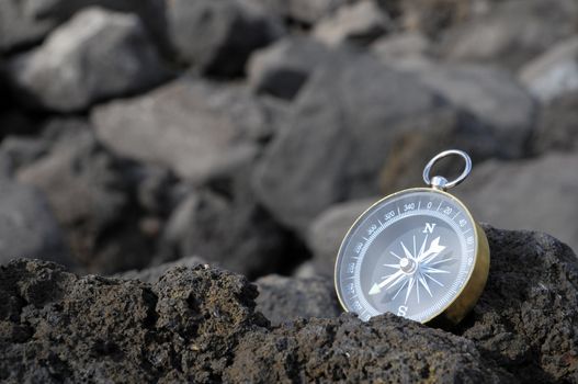 Orientation Concept - Analogic Compass Abandoned on the Rocks