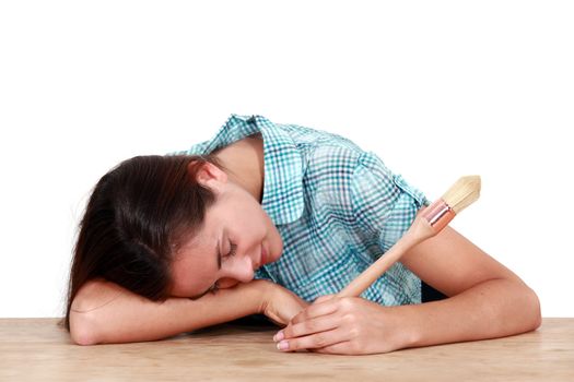 Woman with a brush sleeping on a desk