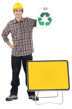 Manual worker stood with recycle poster