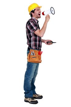 craftsman holding a walkie talkie and shouting through a megaphone