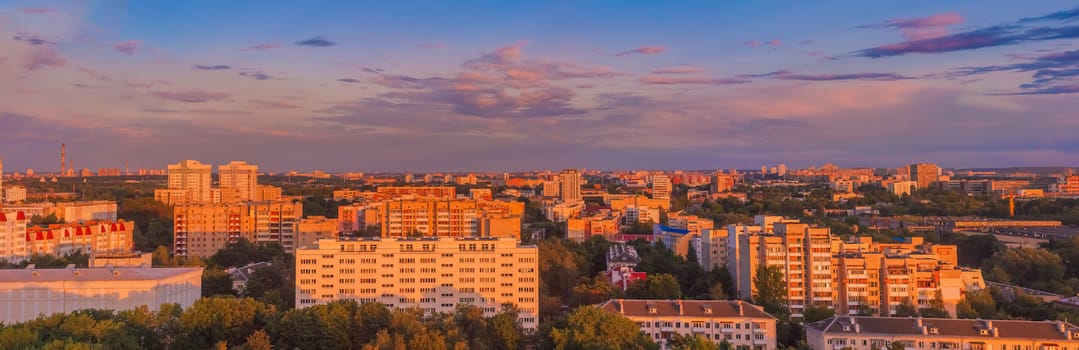 Buildings In A City In An Environment Of Green Trees At Sunset. Panoramic View Minsk - The Capital Of Belarus