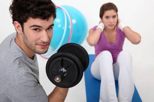 Couple exercising at the gym together