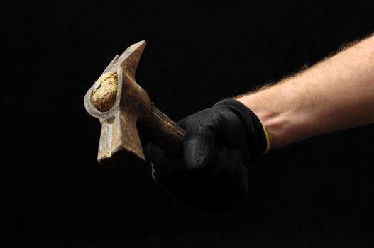 Hammer and a Hand on a Black Background